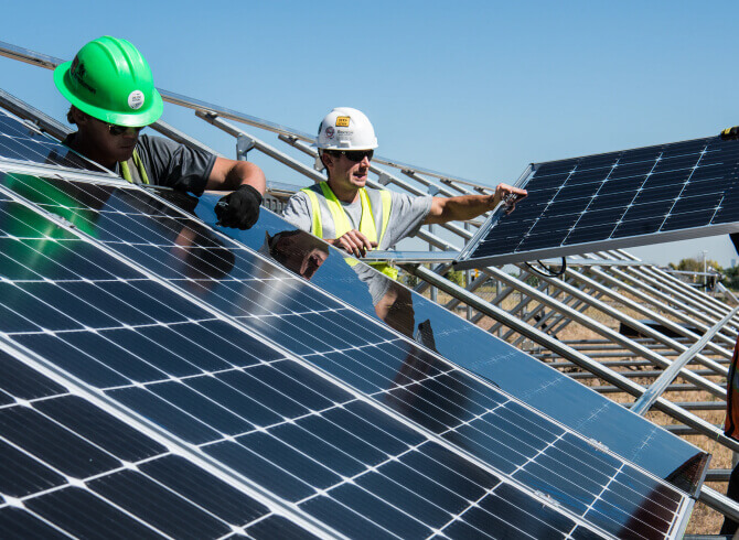workers with solar panels